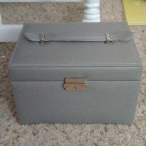 Grey jewelry box with a silver lock with keys
